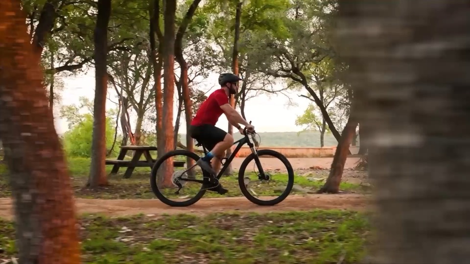 A cyclist riding through a park